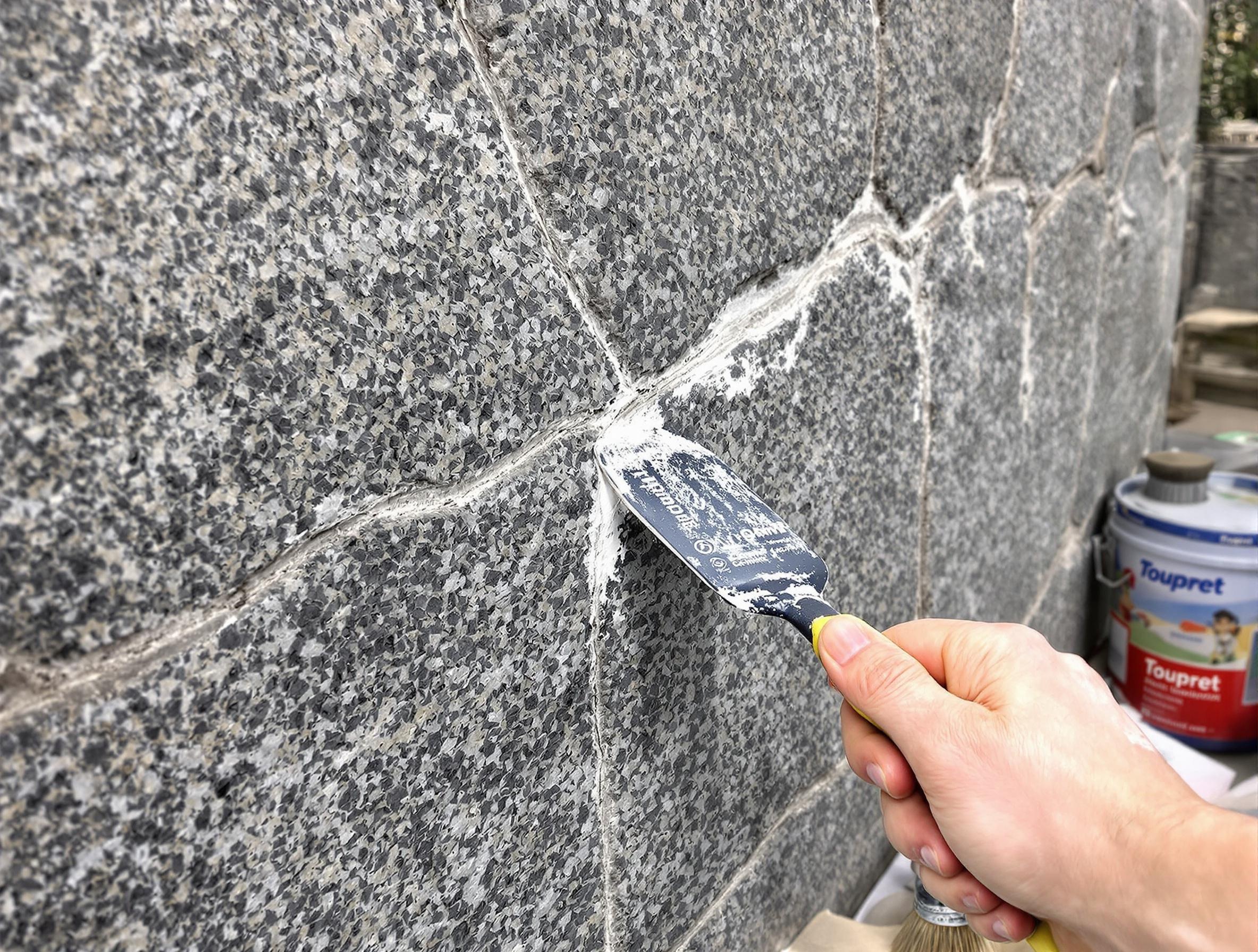 Application d'un enduit de rebouchage Toupret ou Semin sur une fissure de granit breton